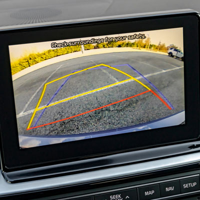Car Reverse Backup Camera installed in the dash and displaying graphic guidelines for backing up